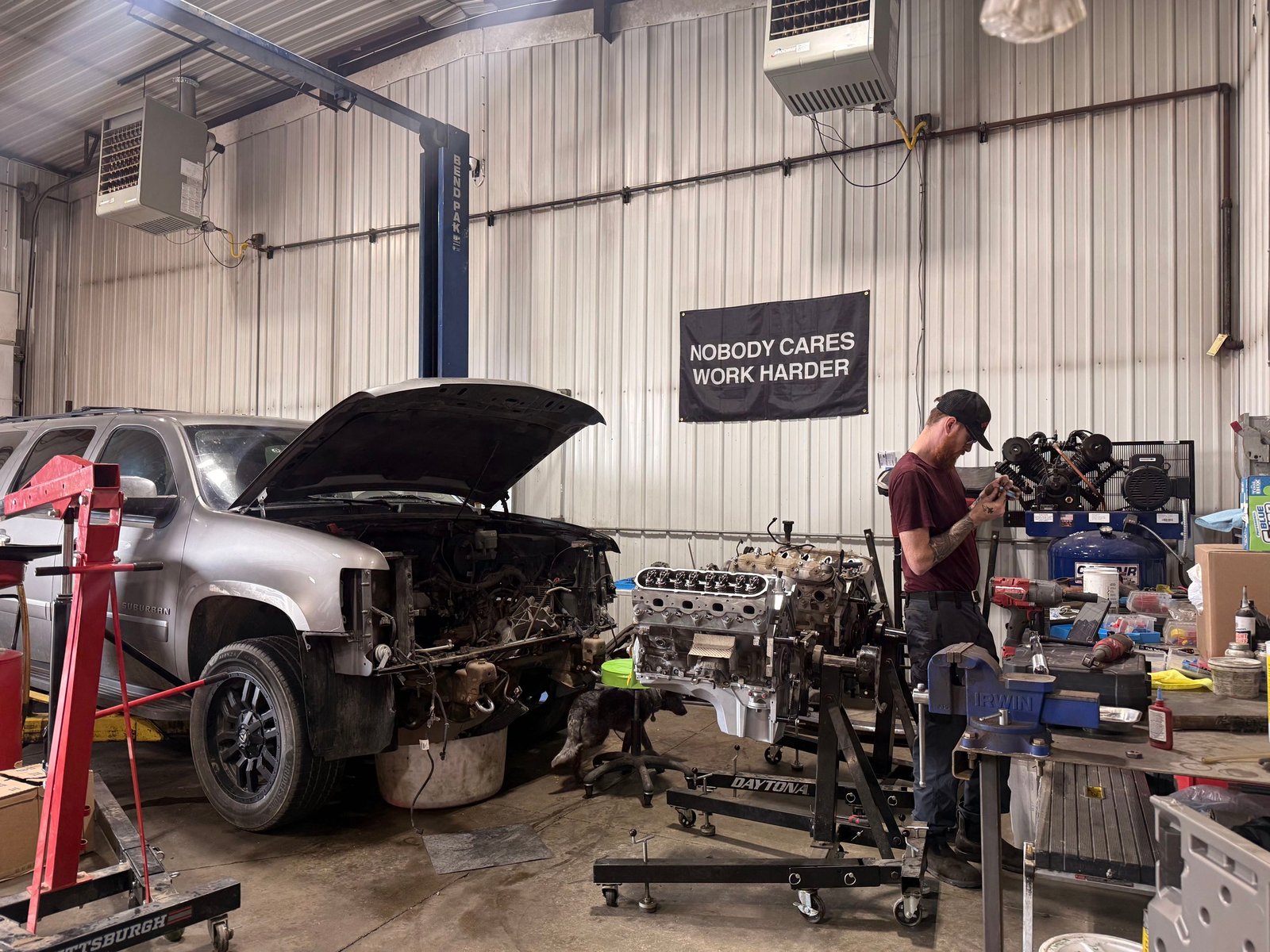 Engine assembly work on a silver SUV at Precision Auto Repair