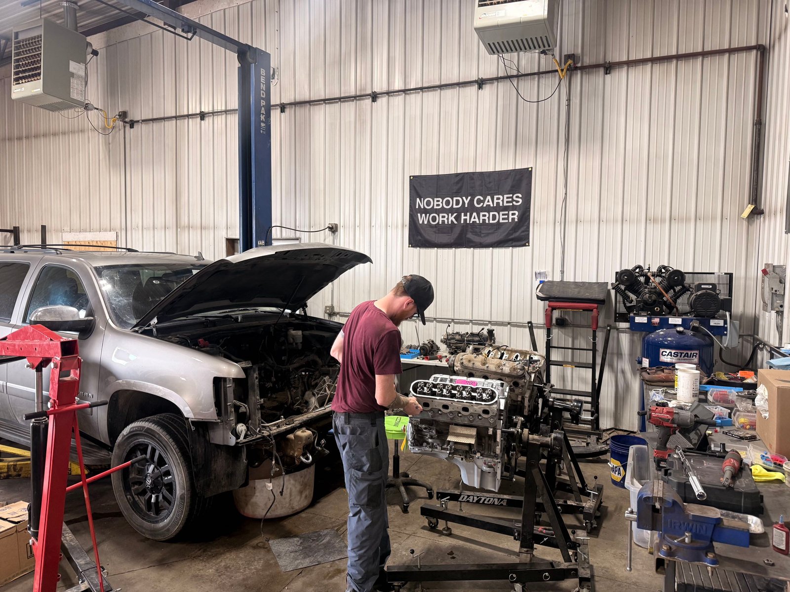 Silver SUV engine repair work inside the Precision Auto Repair shop