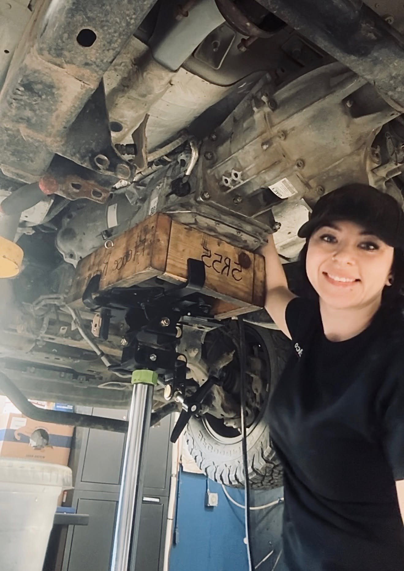 Precision Auto Repair team member working underneath a vehicle