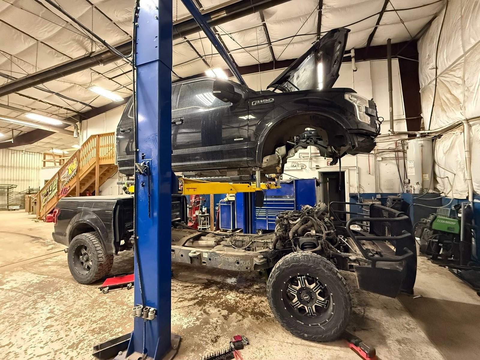 Ford truck lifted during major repair work at Precision Auto Repair